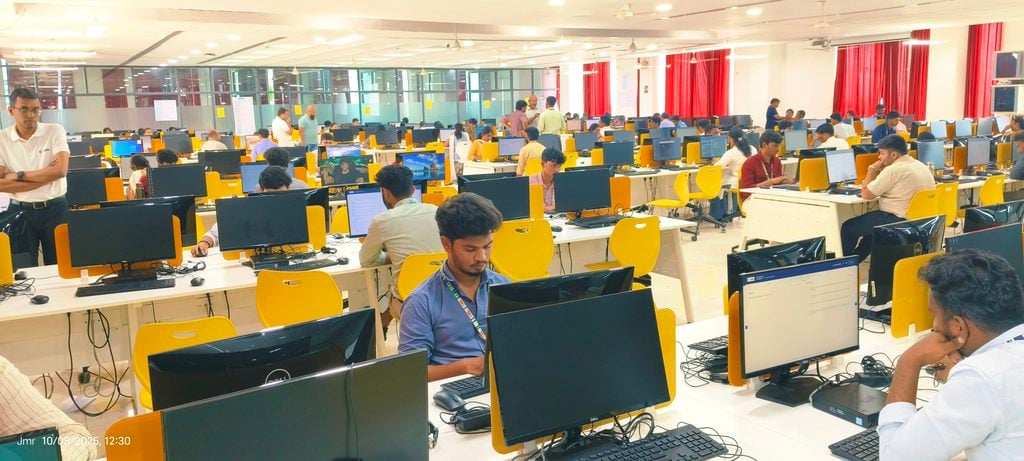 Calibo AI Academy engineering students working at desktop computers in a large computer lab during a hands-on AI learning session.